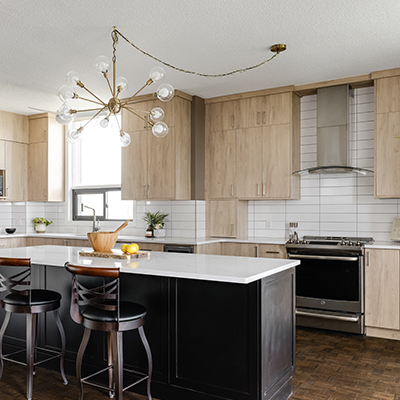 modern kitchen featuring cabinetry, countertops, backsplash and high end appliances